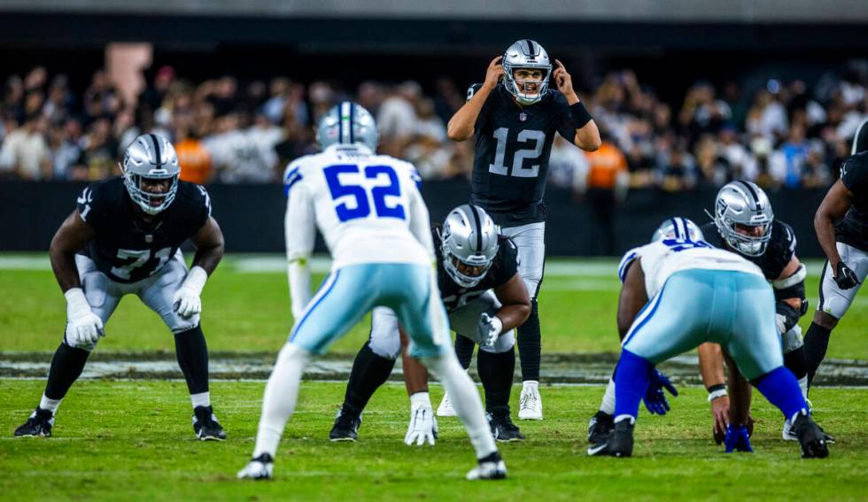 Raiders quarterback Aidan O'Connell (12) signals to teammates against the Dallas Cowboys during ...