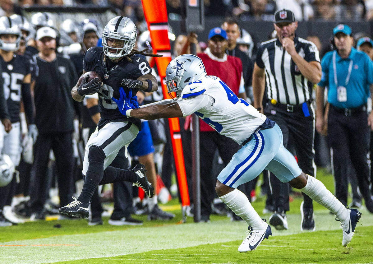 Raiders running back Ameer Abdullah (8) is pushed out of bounds after a catch and run by Dallas ...