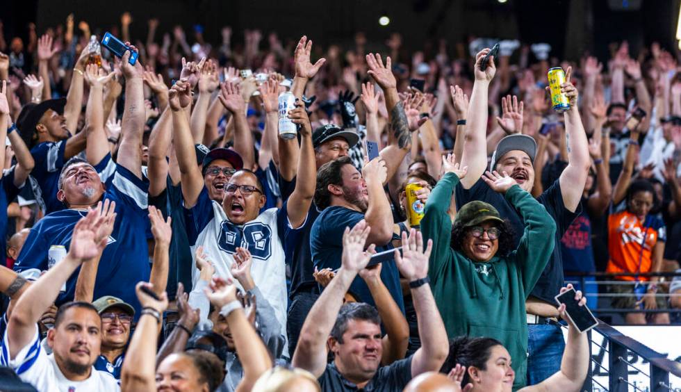 Fans do the wave as the Raiders battle the Dallas Cowboys during the second half of their NFL p ...