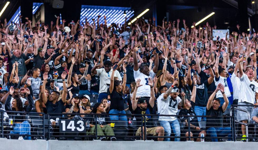 Fans do the wave as the Raiders battle the Dallas Cowboys during the second half of their NFL p ...