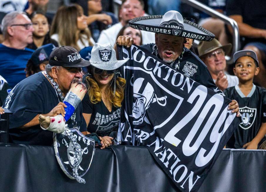 Raiders fans stay excited against the Dallas Cowboys during the second half of their NFL presea ...