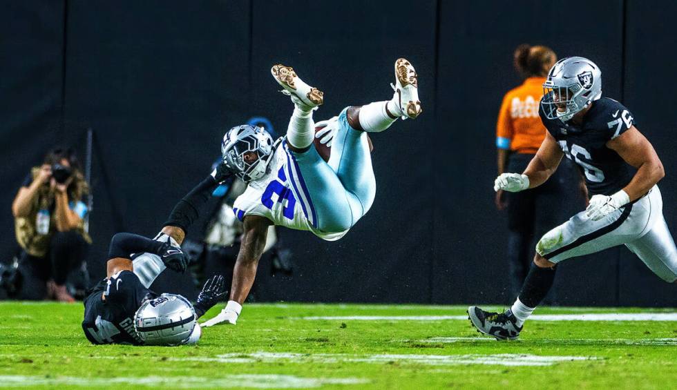 Dallas Cowboys running back Snoop Conner (32) is upended near the end zone by Raiders safety Ja ...