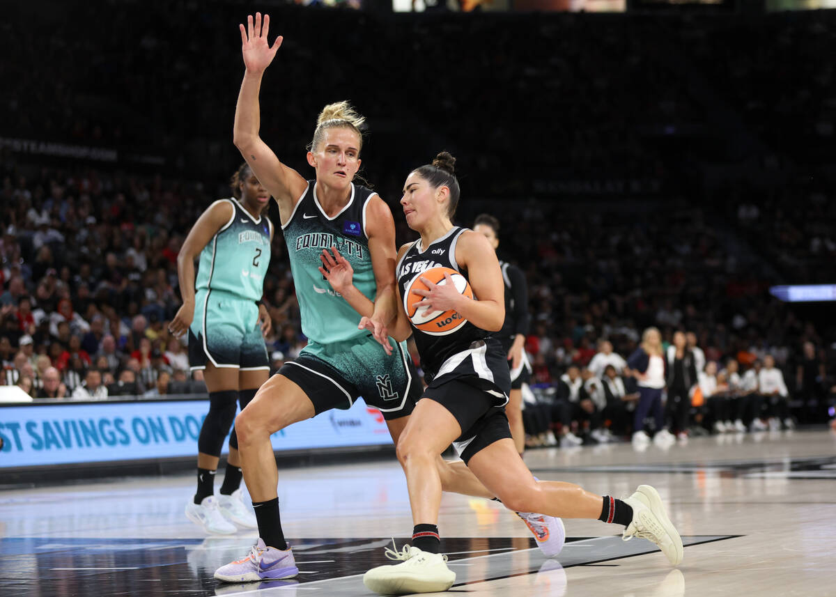 Las Vegas Aces guard Kelsey Plum (10) drives toward the hoop against New York Liberty forward L ...