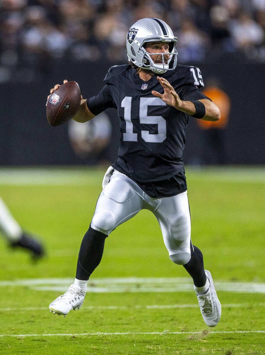 Raiders quarterback Gardner Minshew (15) looks for a receiver on the run against the Dallas Cow ...