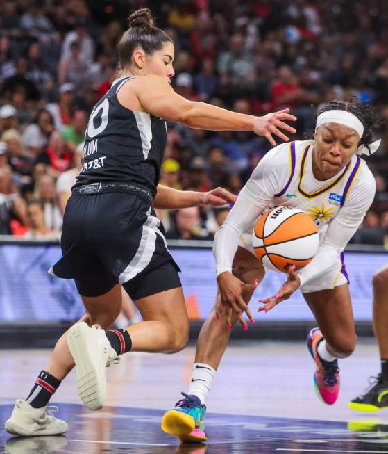 LA Sparks guard Odyssey Sims (6) struggles to keep hold of the ball as Aces guard Kelsey Plum ...