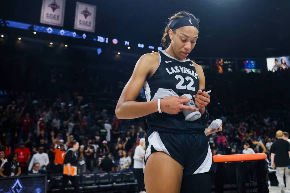 Aces center A'ja Wilson (22) signs shirts for fans following a WNBA basketball game between the ...