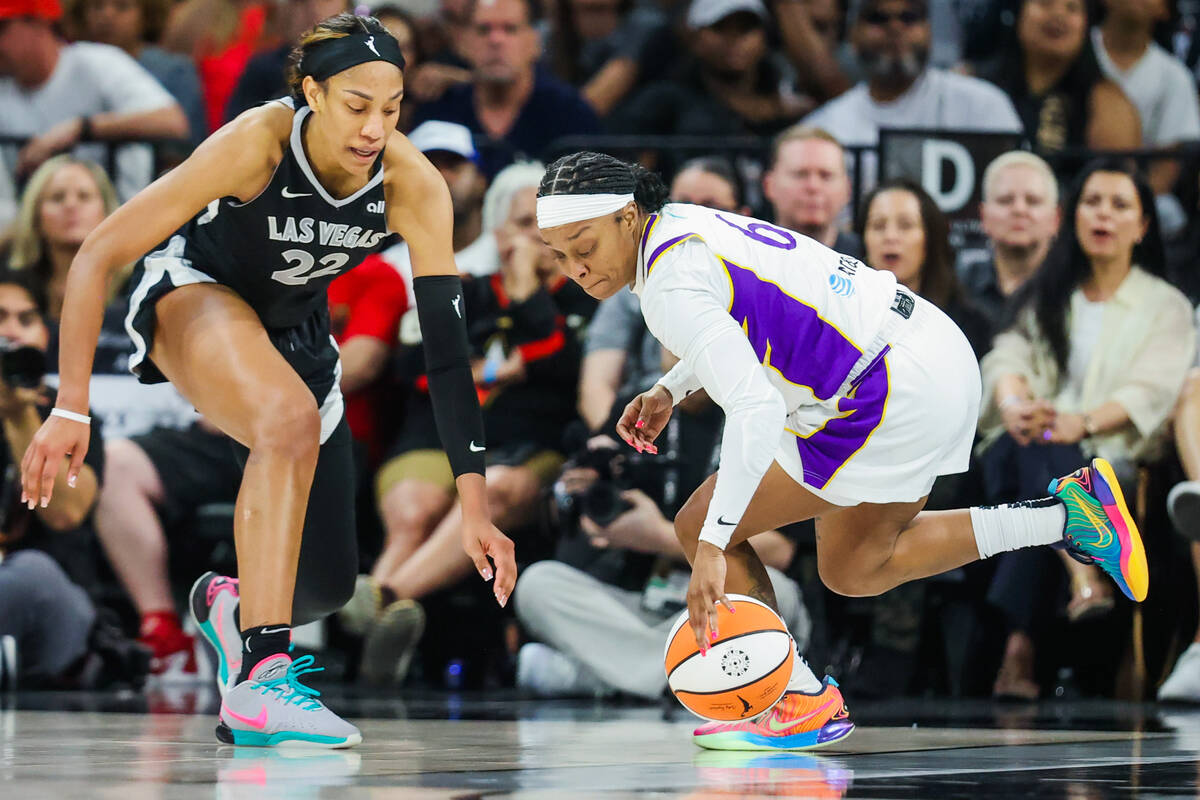 LA Sparks guard Odyssey Sims (6) and Aces center A'ja Wilson (22) chase after a loose ball duri ...