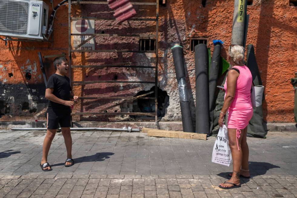 People look at the damage after a bomb explosion in Tel Aviv, Israel, Monday, Aug. 19, 2024. (A ...