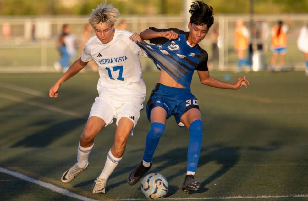 Sierra Vista defender Lucas Rossetti (17) and Basic junior Bruno Balcazar (30) compete for the ...