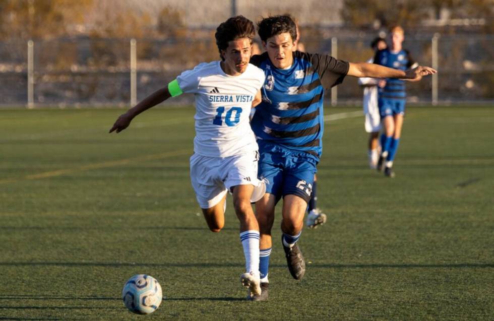 Sierra Vista senior Lazzar Ramos (10) and Basic junior Jeff Sesock (23) compete for the ball du ...