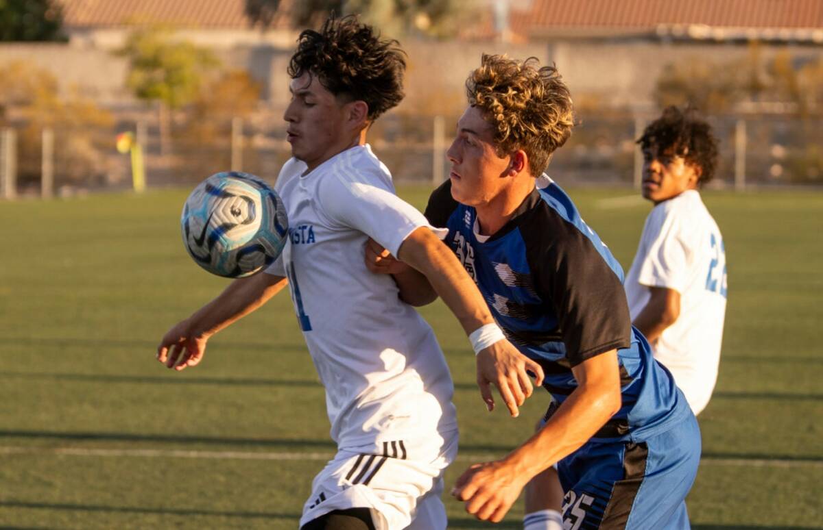 Sierra Vista midfielder Edwin Cruz (11) and Basic junior Cash Black (35) compete for the ball d ...