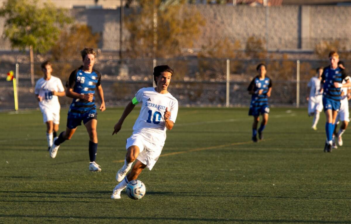 Sierra Vista senior Lazzar Ramos (10) moves the ball up the field during the high school soccer ...