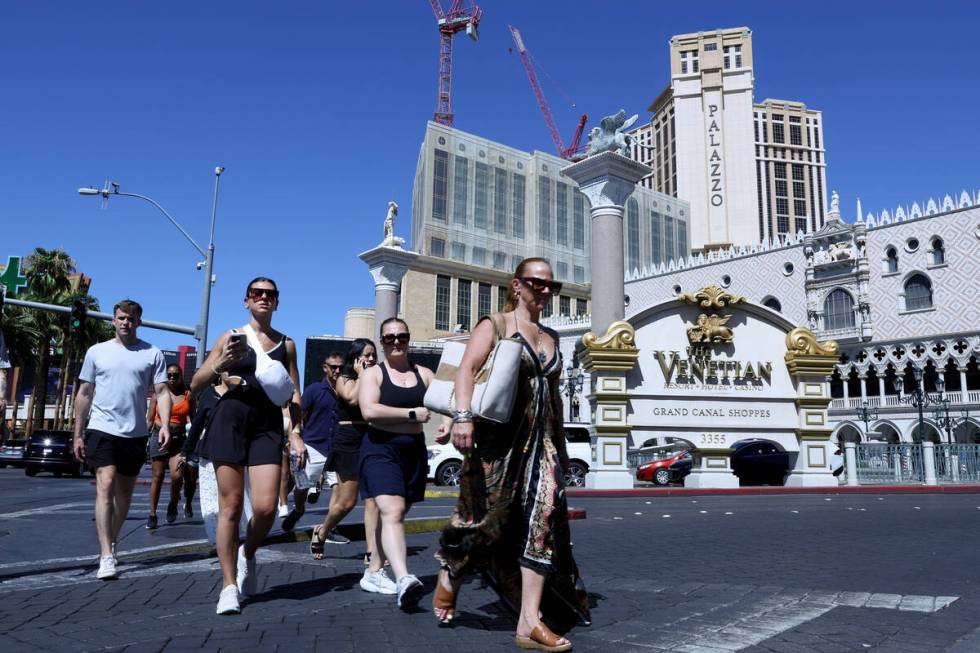 Pedestrians pass Venetian and Palazzo on Tuesday, Aug. 20, 2024, on the Las Vegas Strip. (Ellen ...