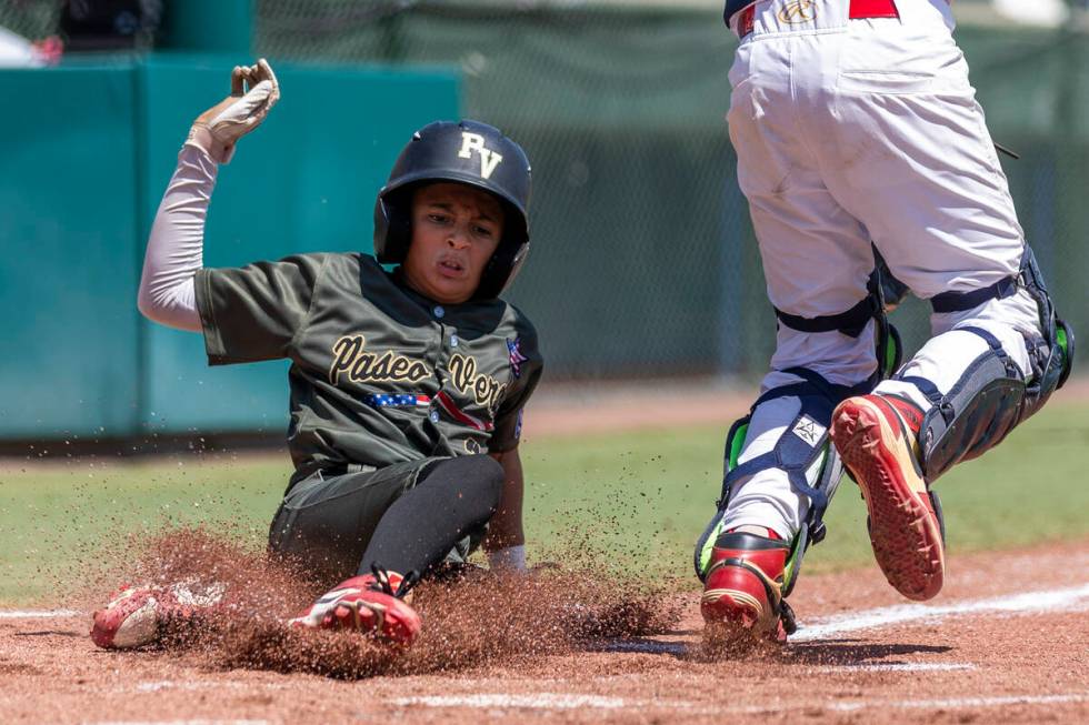 Nevada's Russell McGee (2) slides safely home for their first run against Utah during the ...