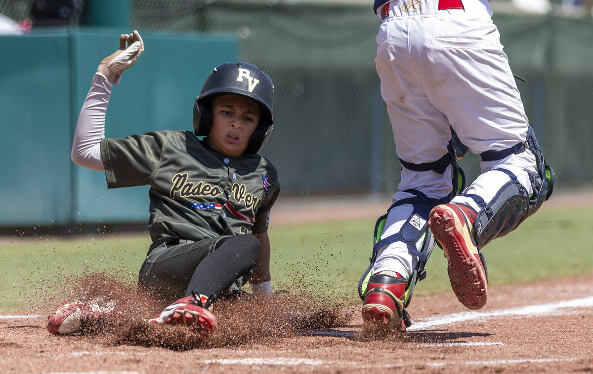 Nevada's Russell McGee (2) slides safely home for their first run against Utah during the ...