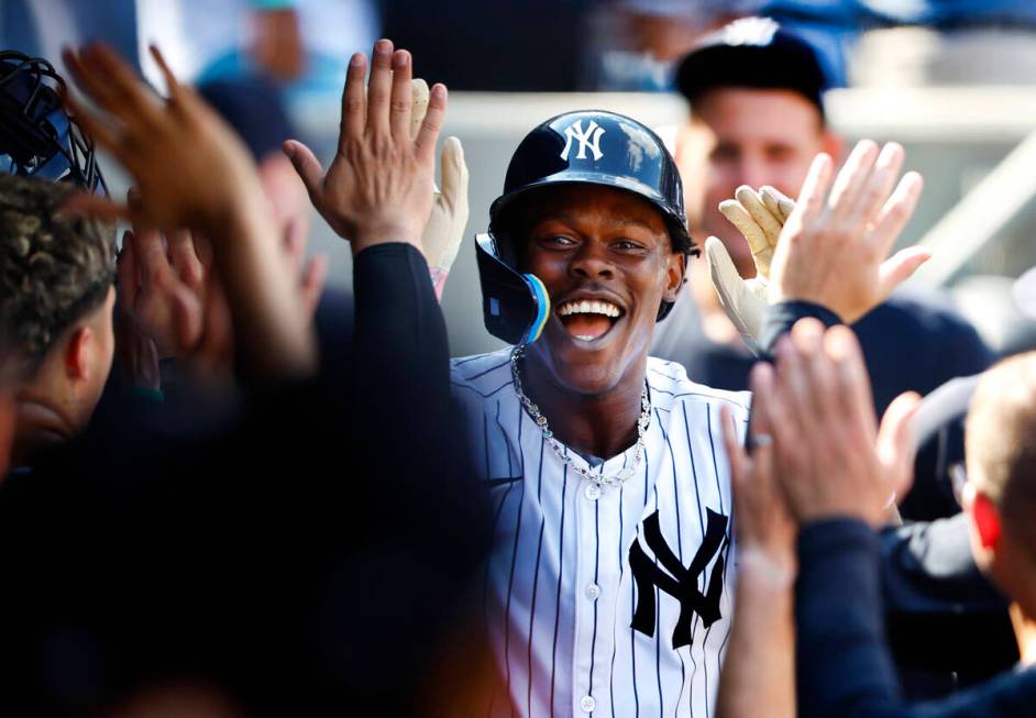 New York Yankees' Jazz Chisholm Jr. (13) celebrates in the dugout with teammates after hitting ...