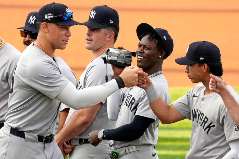 New York Yankees' Aaron Judge, left, is videotaped by Jazz Chisholm, center, as he his introduc ...