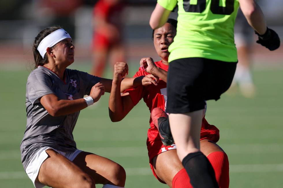 Arbor View forward Danielle Morales, left, and Coronado defender Paige Baptist, center, brace t ...