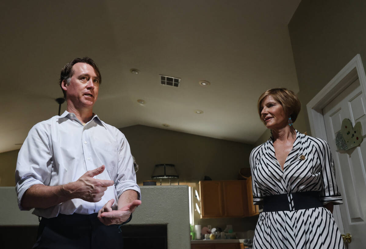 William Huggins speaks with Rep. Susie Lee, D-Nev., at his home in Las Vegas on Tuesday, Aug. 2 ...