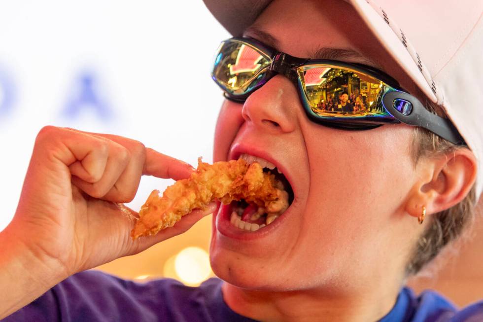 Olympic medalist Katie Grimes eats a chicken finger during a promotional homecoming “shi ...