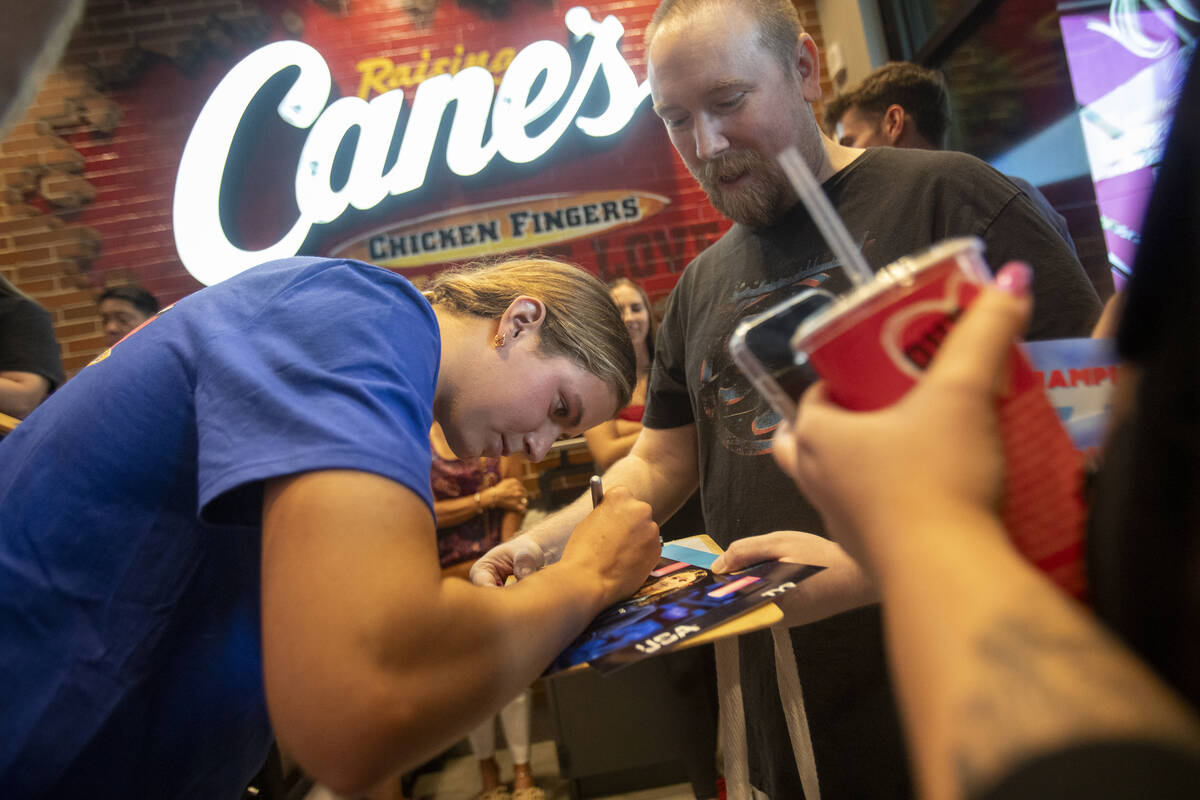 Olympic medalist Katie Grimes signs photographs during a promotional homecoming “shift&# ...