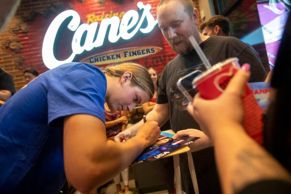 Olympic medalist Katie Grimes signs photographs during a promotional homecoming “shift&# ...