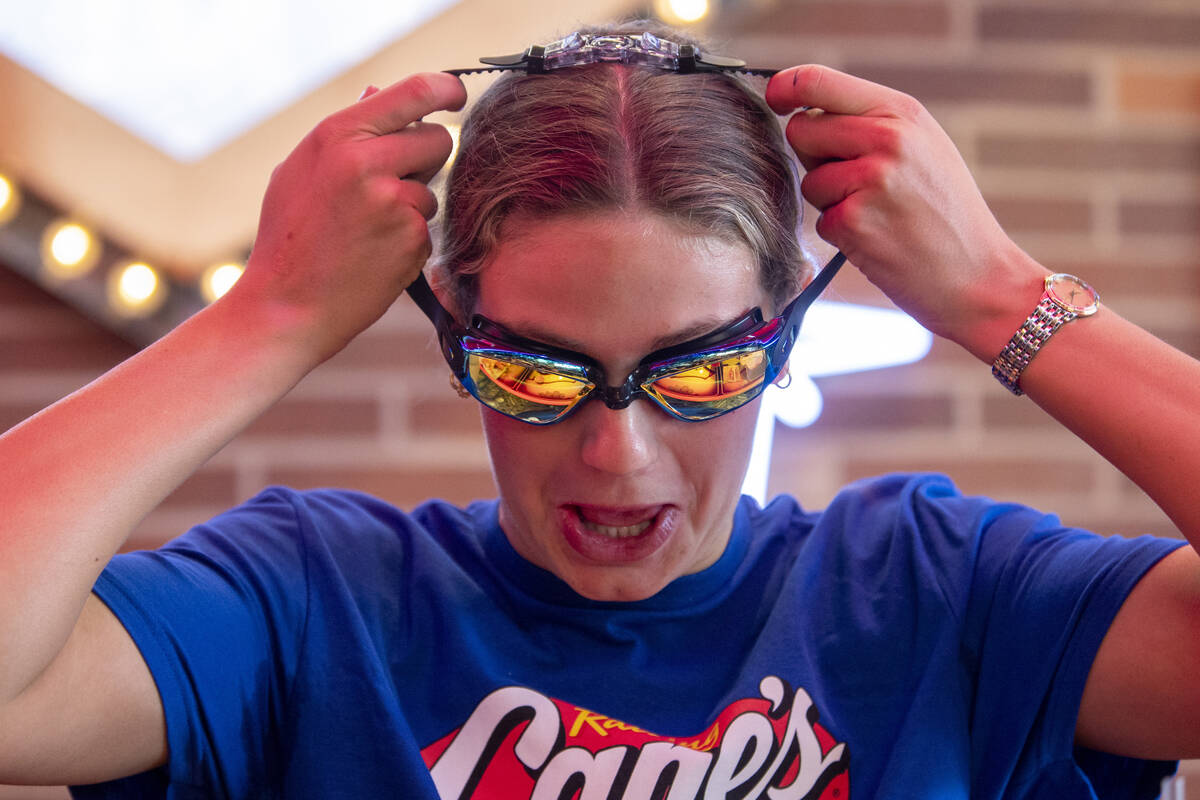 Olympic medalist Katie Grimes adorns a pair of goggles during a promotional homecoming “ ...