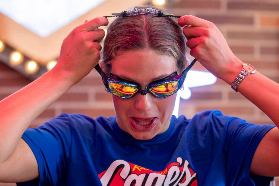 Olympic medalist Katie Grimes adorns a pair of goggles during a promotional homecoming “ ...