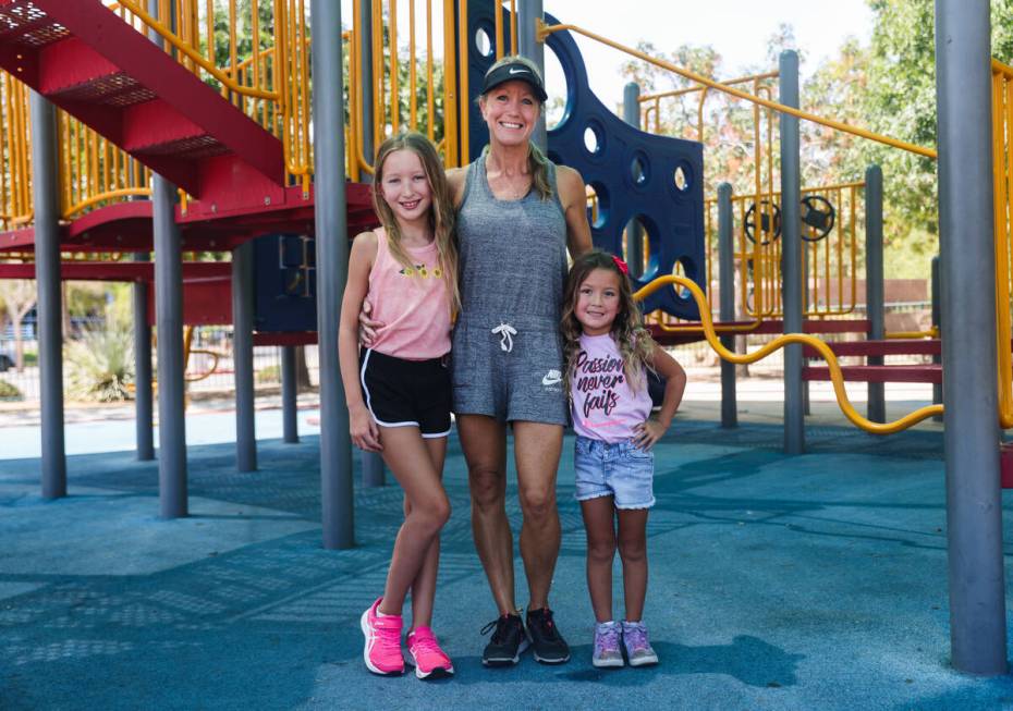 Kim Benitez, who suffered a stroke at age 35, center, poses for a portrait with her daughters A ...