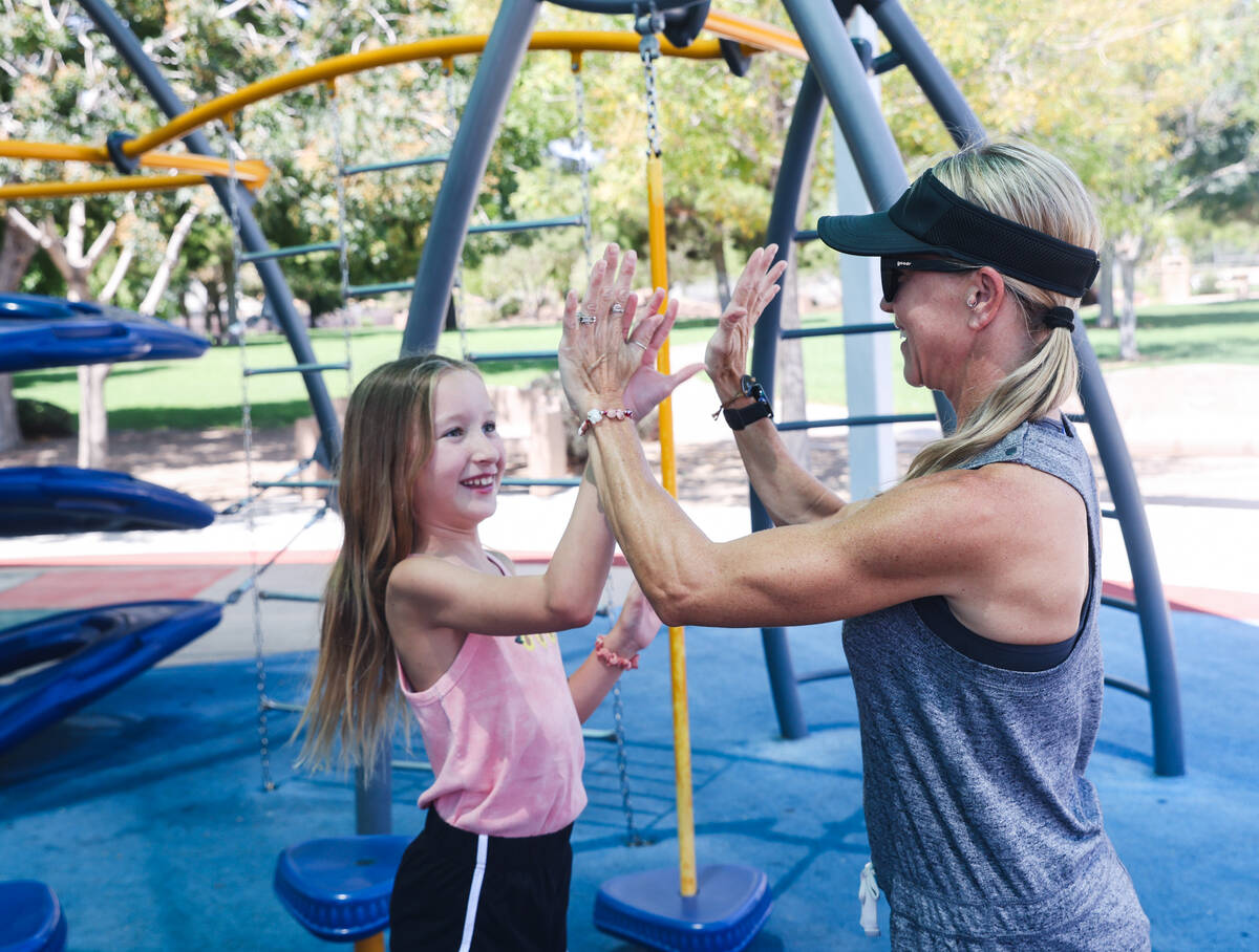 Kim Benitez, who suffered a stroke at age 35, high-fives her daughter Aryanna Benitez, 10, at S ...