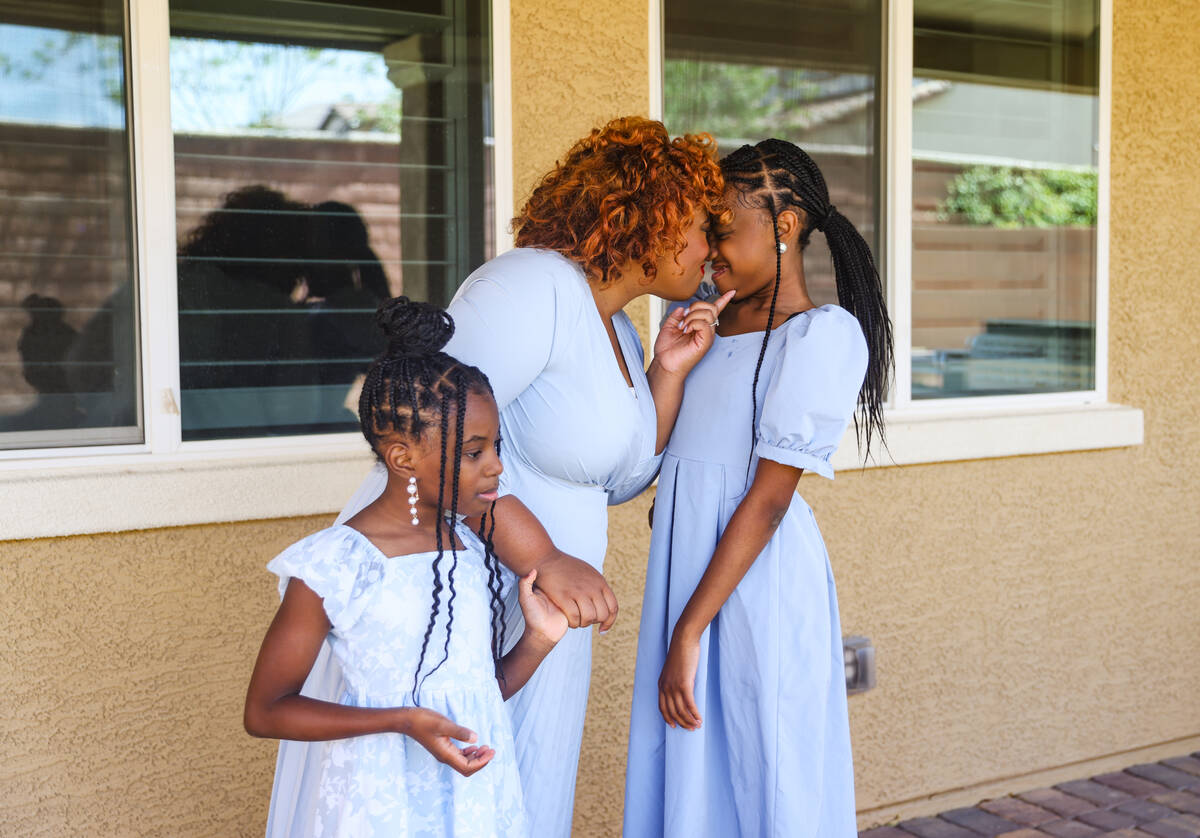 Rosemary Wade, a stroke survivor, snuggles with her daughter Serenity Wade, 12, while holding t ...