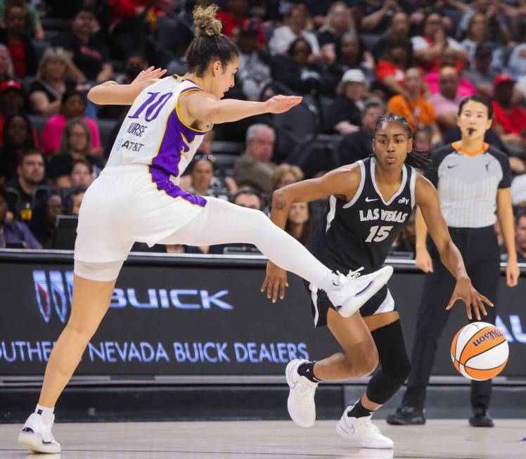 Aces guard Tiffany Hayes (15) dribbles the ball as Los Angeles Sparks guard Kia Nurse (10) guar ...