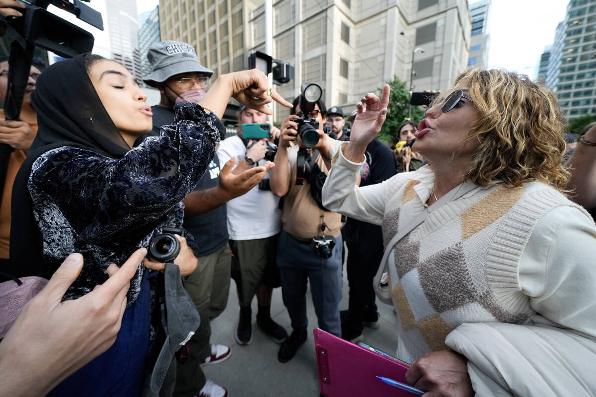 A demonstrator and a counter protester argue near the Israeli Consulate during the Democratic N ...