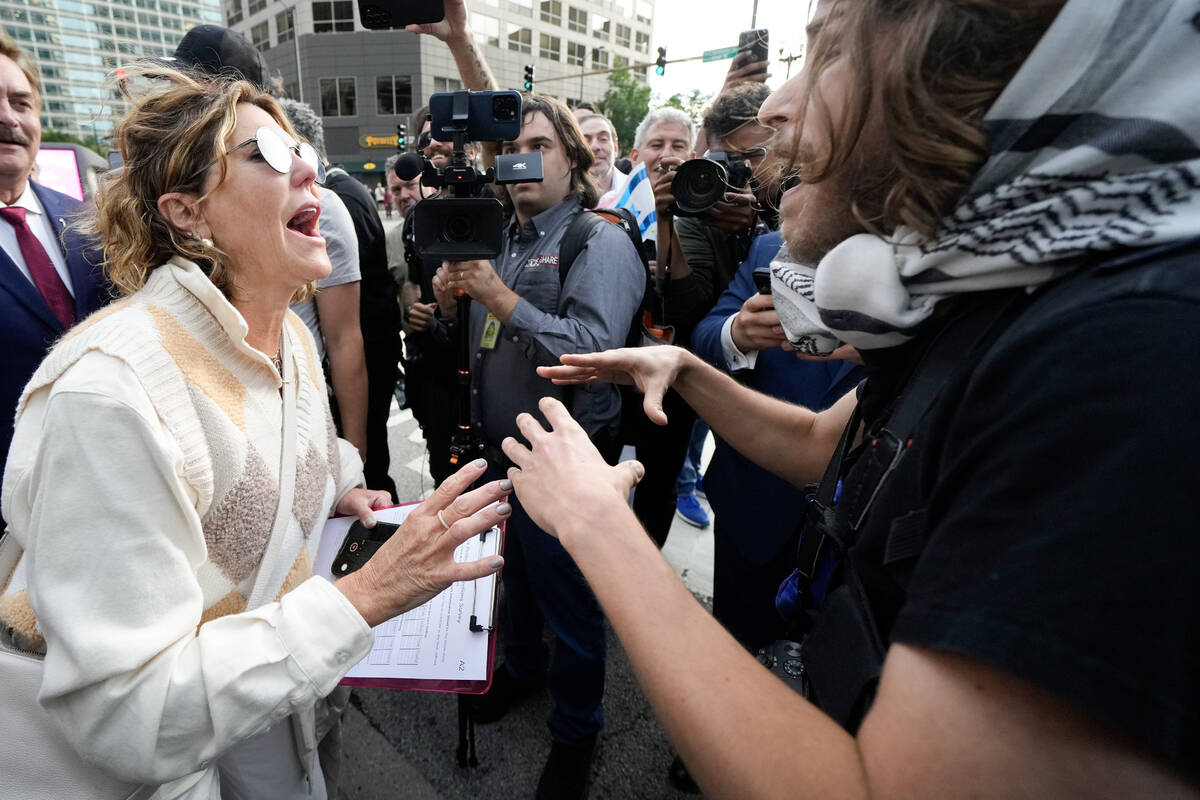 A demonstrator and a counter protester argue near the Israeli Consulate during the Democratic N ...