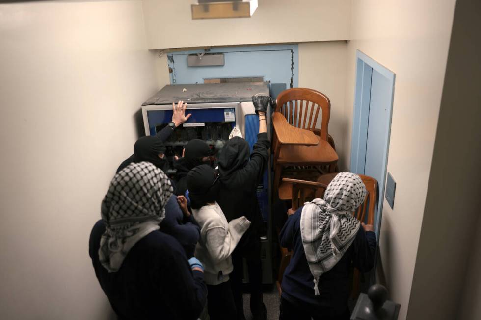 Demonstrators from the pro-Palestine encampment barricade themselves inside Hamilton Hall, an a ...