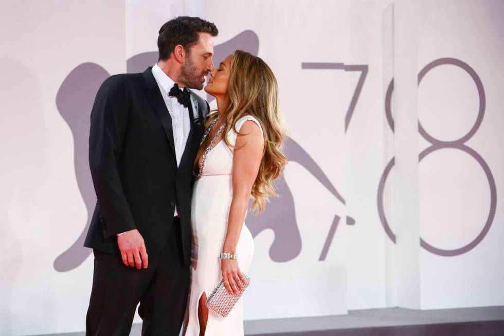 Jennifer Lopez, right, and Ben Affleck kiss at the premiere of the film "The Last Duel" during ...