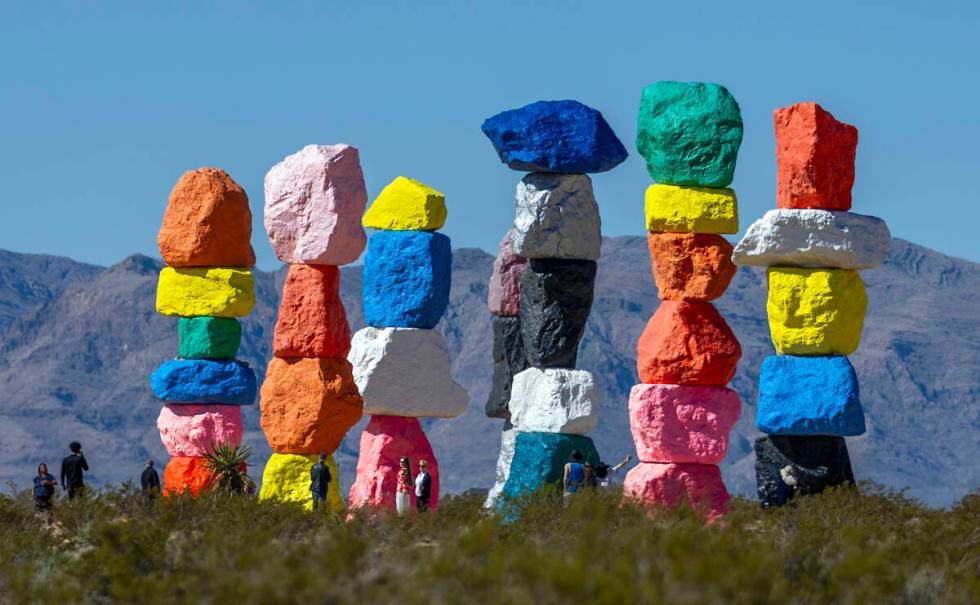 Visitors stop by to see the Seven Magic Mountains art installation on Wednesday, March 20, 2024 ...