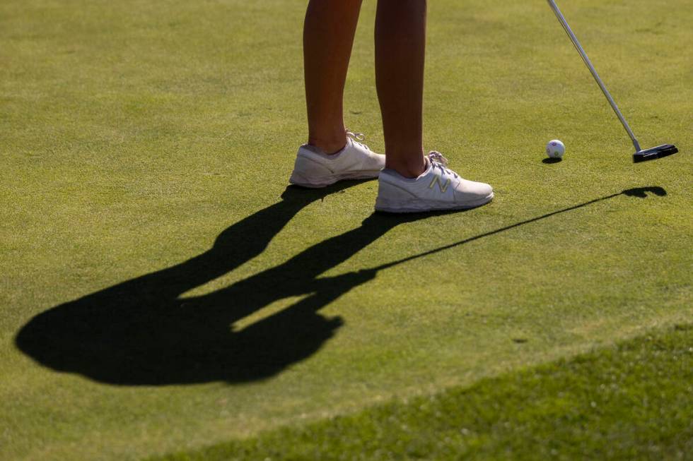 Faith Lutheran’s Scarlett Schneider prepares to putt the ball during the 5A Desert Leagu ...