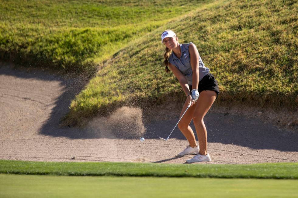 Faith Lutheran’s Scarlett Schneider attempts to chip onto the green from the bunker duri ...