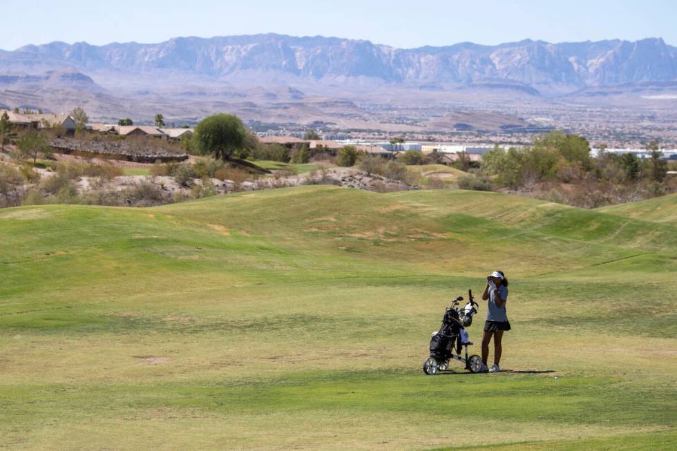 Faith Lutheran’s Macy Garth uses a rangefinder during the 5A Desert League girls golf ma ...