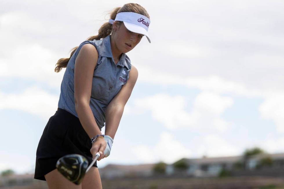 Faith Lutheran’s Scarlett Schneider looks at her club before teeing off during the 5A De ...