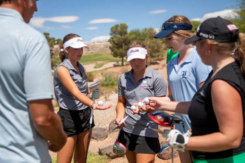 Members of group five show the design of their golfballs before teeing off during the 5A Desert ...