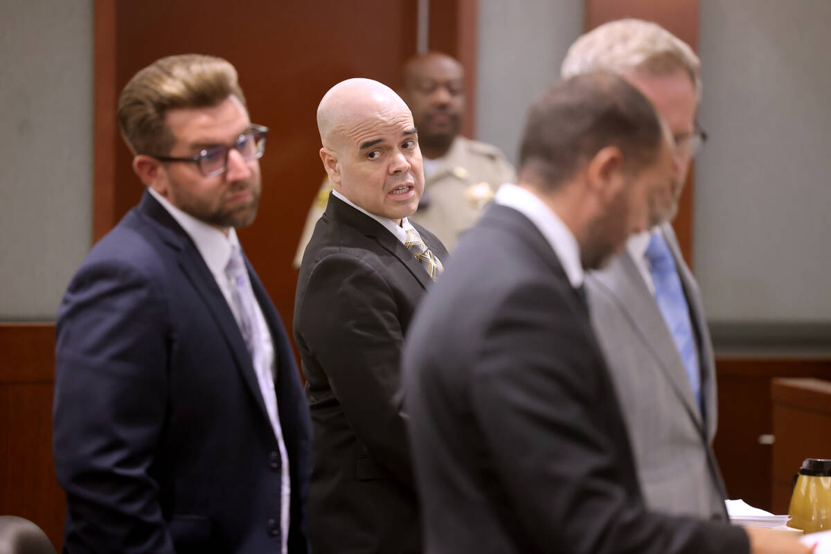 Robert Telles, second from left, stands as the jury exits the courtroom on the sixth day of his ...