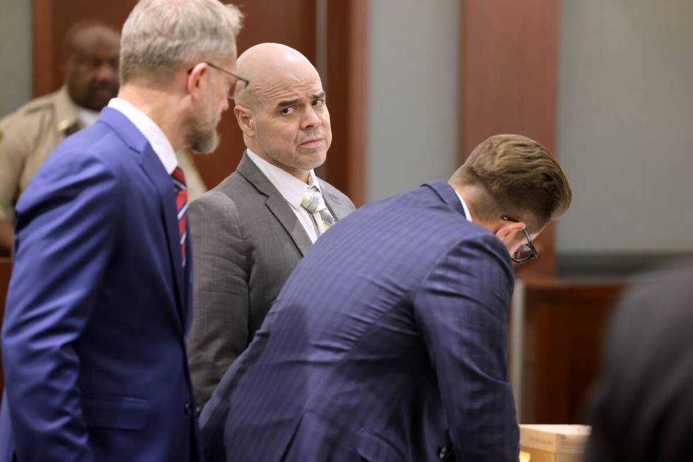 Robert Telles, center, talks to his attorneys Robert Draskovich, left, and Michael Horvath in c ...