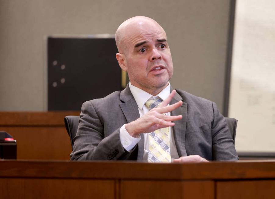 Robert Telles shows how he cut his finger while speaking to the jury from the witness stand on ...