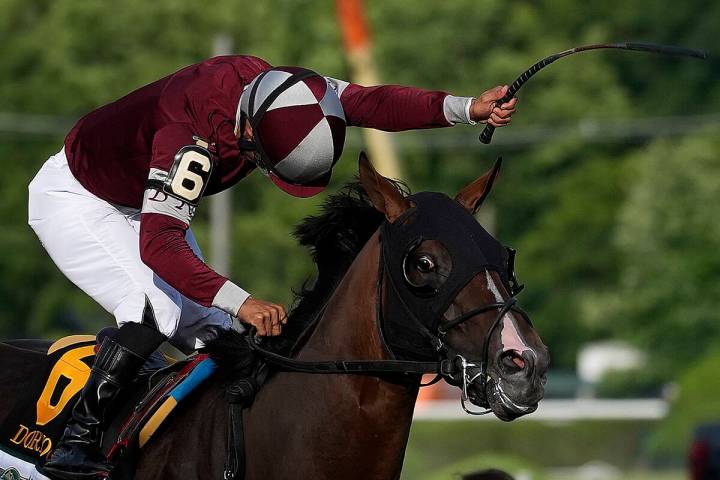 Jockey Luis Saez (6) reacts after crossing the finish line with Dornoch to win the 156th runnin ...