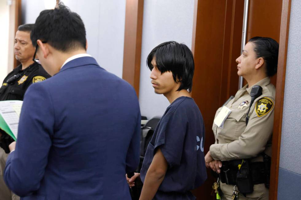 Joshua Robles, center, who is facing terrorism-related charges, appears in court during a heari ...