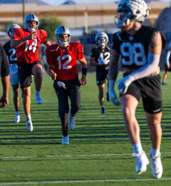 Raiders quarterback Carter Bradley (14) catches some air beside quarterback Aidan O'Connell (12 ...