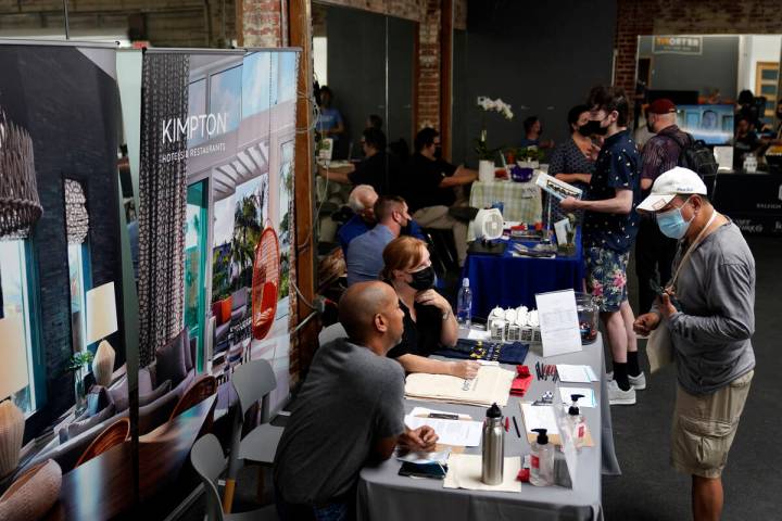 Prospective employers and job seekers interact during during a job fair on Sept. 22, 2021, in t ...