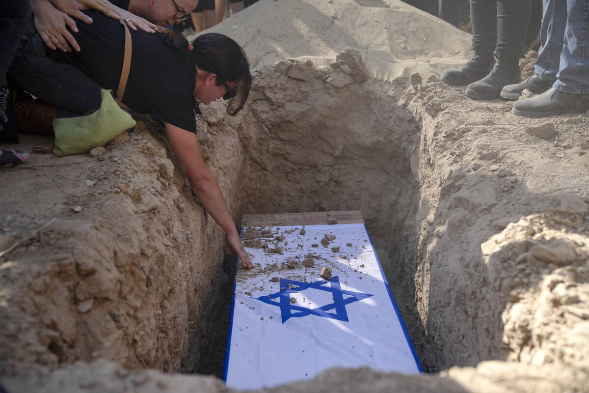 Rimon Buchshtab mourns during the funeral of her husband Yagev Buchshtab at a cemetery of the K ...